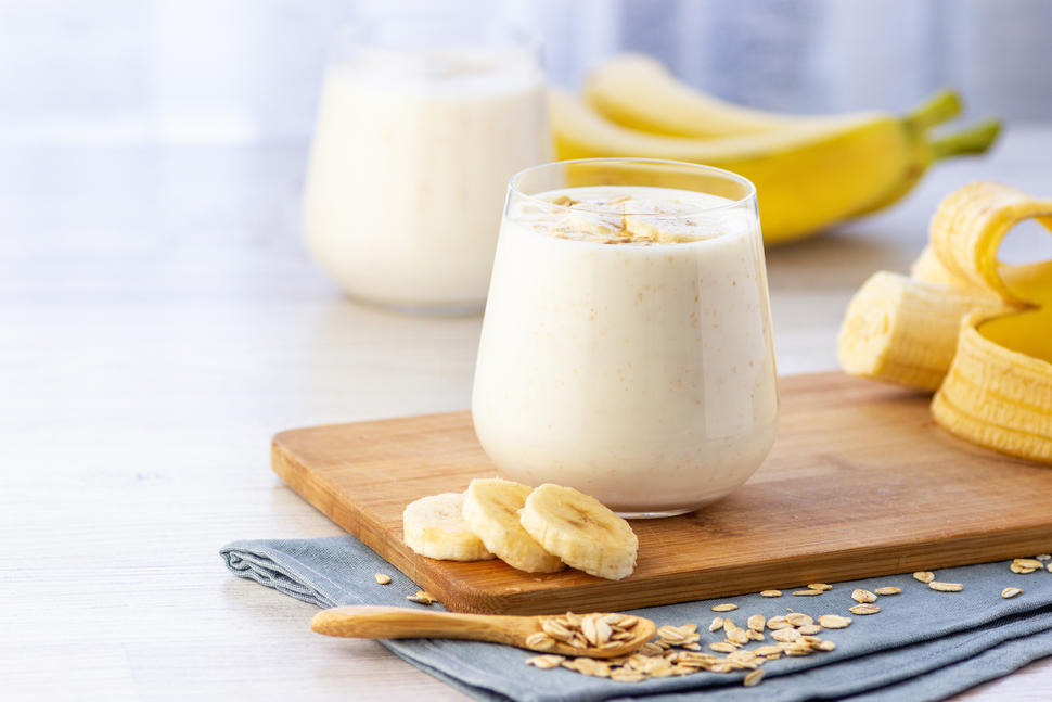 Overnight oats in a decorative glass, garnished with banana slices.